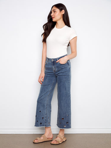 These medium blue jeans feature a regular rise and charming heart cutouts at the hem for a playful touch by Charlie B.