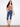 Model in medium blue capri jeans featuring a sleek slim fit and knee length. Crafted with stretch denim for comfort by Charlie B.