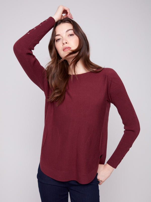 Sweater in cabernet showcasing long ribbed sleeves and a flattering rounded hem design by Charlie B.