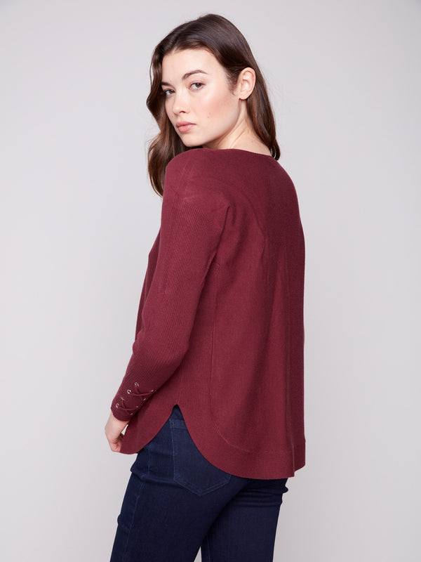 Chic cabernet knit sweater with lace-up cuffs, adding a touch of elegance to any outfit by Charlie B.