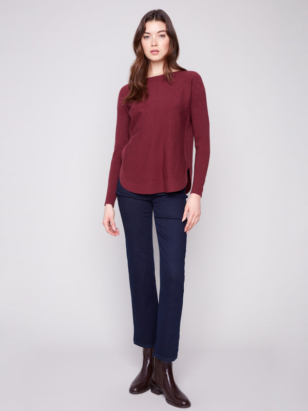 Knit sweater in rich cabernet color, offering comfort with its boat neck design and ribbed sleeves by Charlie B.
