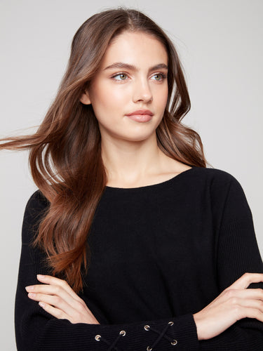 Elegant black knit sweater with lace-up cuff detail adding a touch of sophistication to your wardrobe by Charlie B.