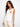 Ecru knit tank top featuring a sleeveless design and crochet heart pocket detail by Charlie B.