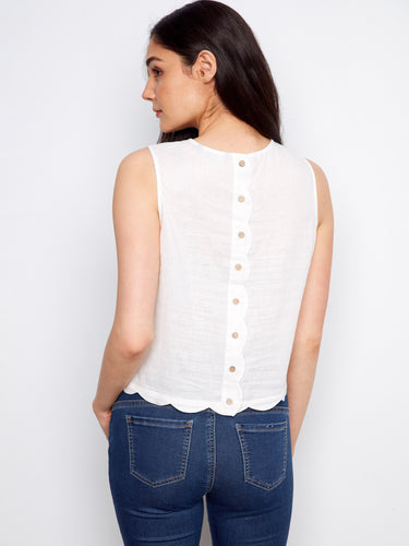 Elegant crew neckline on a sleeveless white top enhances style, by Charlie B.