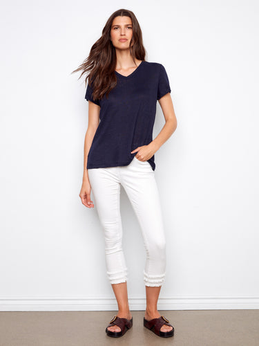 Navy short-sleeve T-shirt in a relaxed fit, styled effortlessly with white pants by Charlie B.