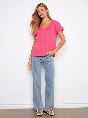 This pink T-shirt showcases a stylish drop shoulder design, adding a relaxed vibe to any outfit. Made by Charlie B.