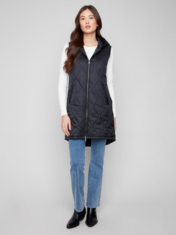Black long vest with quilted texture and a sleek zipper front closure by Charlie B.