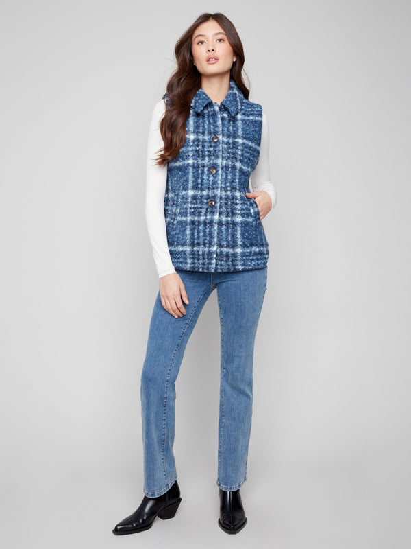 Stay cozy with this plaid boucle knit vest, complete with welt pockets and stylish design by Charlie B.