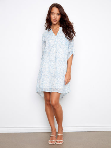 Light blue Henley shirt dress with chest pocket and 3/4 sleeves, offering a relaxed fit by Charlie B.