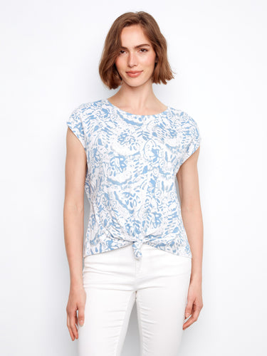 Blue floral top with a crew neckline, featuring a stylish front tie knot at the hem. Made from 100% cotton for comfort by Charlie B.