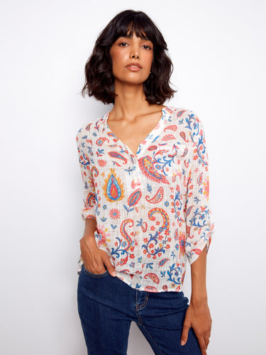 Floral blouse with a Henley neckline and vibrant paisley print, perfect for casual outings. Designed by Charlie B.
