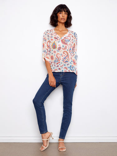 Stylish half-button blouse featuring a colorful floral pattern, ideal for adding flair to your wardrobe. By Charlie B.