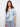 Floral blouse with a Henley neckline, showcasing a blend of blue and white hues. Perfect for casual outings. By Charlie B.
