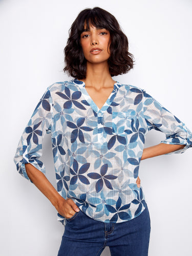 Women's blouse with a floral pattern and chest pocket, showcasing a stylish Henley neckline by Charlie B.