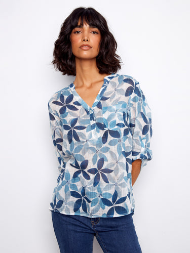 Elegant women's blouse with half-button design in a striking floral print by Charlie B.
