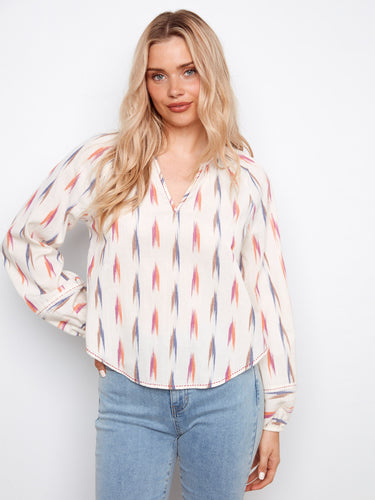 Ikat blouse featuring elastic cuffs and a rounded hem, offering a relaxed yet chic look by Charlie B.