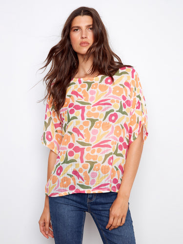 Vibrant abstract print blouse featuring a relaxed fit and lightweight cotton blend by Charlie B.