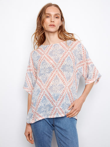 The top features a crew neckline and a relaxed fit, perfect for casual outings. Crafted in a lightweight cotton blend. By Charlie B.
