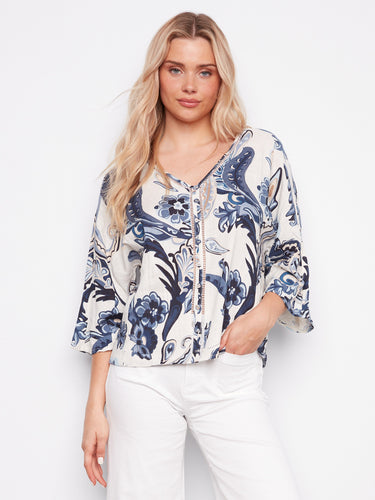 A blouse with a striking paisley pattern, featuring wide 3/4 sleeves and decorative buttons by Charlie B.