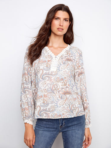 Stylish blouse showcasing a beautiful paisley print and raglan sleeves by Charlie B.