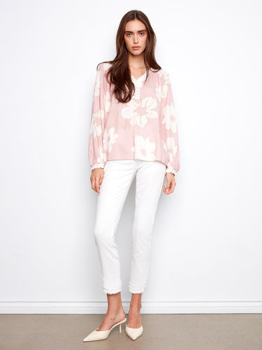 Chic pink floral top featuring a notch neckline and intricate crochet details on cuffs for a stylish touch by Charlie B.