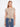 Beige printed blouse featuring a stylish boat neckline and cap sleeves, complete with a tie-front detail by Charlie B.