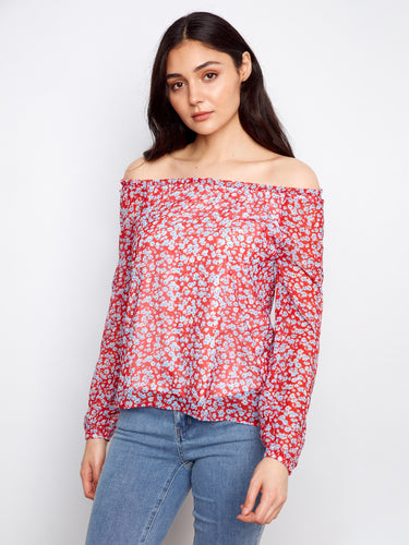Red blouse with off-the-shoulder neckline and charming floral design, paired with jeans for a casual look by Charlie B.