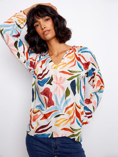 A chic top adorned with a notched neckline and eye-catching colors, perfect for any occasion. By Charlie B.