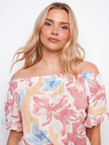 This top features short flutter sleeves that add a playful touch to your outfit by Charlie B.