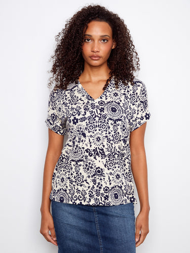 Floral-patterned top with a V neckline and short dolman sleeves, perfect for casual outings. Made from a lightweight linen blend by Charlie B.