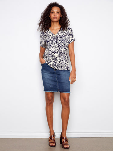 Stylish floral blouse with short dolman sleeves and intricate patterns, ideal for warm days. Crafted in linen blend by Charlie B.
