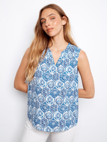 This stylish top features a V-neck design, adding an elegant touch to its intricate blue and white pattern. By Charlie B.
