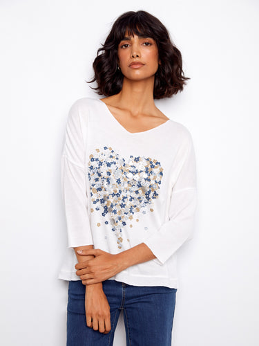 Chic V-neck top with a delicate blue and white placement print pattern, perfect for any occasion by Charlie B.