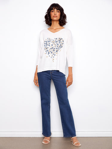 Stylish white top showcasing a beautiful heart-shaped floral design with 3/4 sleeves by Charlie B.