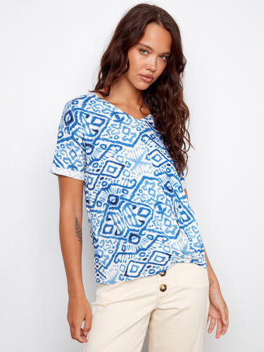 Blue patterned top with a stylish V-neckline, paired elegantly with beige pants. Perfect for casual outings by Charlie B.