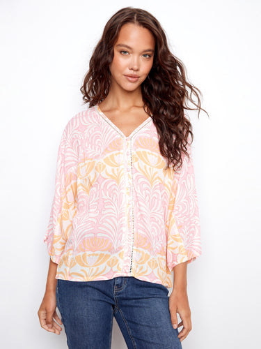 Floral top with wide 3/4 sleeves, showcasing a relaxed fit and intricate pattern. Designed for comfort and style by Charlie B.