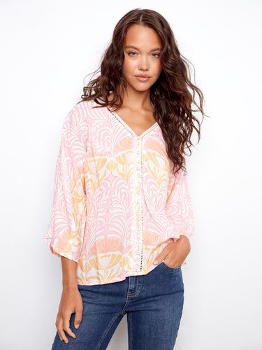 Chic V-neck top with front decorative buttons, perfect for adding elegance to any outfit. A stylish choice by Charlie B.
