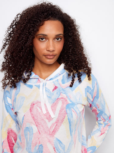 This 100% cotton hoodie showcases a unique and colorful pattern, perfect for adding flair to any outfit by Charlie B.