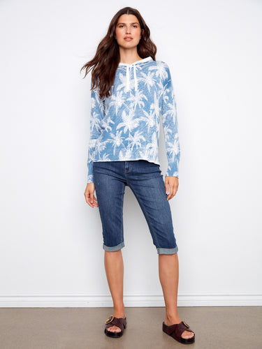 Stylish blue hoodie crafted from 100% cotton, adorned with a palm tree pattern. Ideal for layering during cooler days by Charlie B.