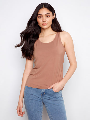 This top features a reversible design for versatile styling, perfect for any occasion. Crafted with care and elegance by Charlie B.