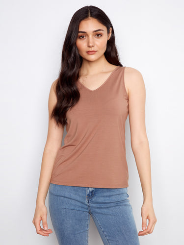 Designed with a stylish V-neck, this top offers both comfort and chic appeal. A must-have addition to your wardrobe by Charlie B.