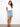 Denim skirt featuring short length and front buttons, styled casually with a white top for a chic look by Charlie B.
