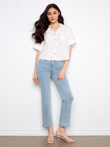 Effortlessly stylish white shirt featuring button-front design, ideal for layering or wearing solo. Designed by Charlie B.