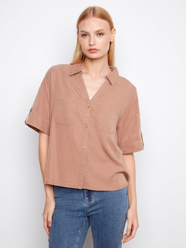 A stylish shirt with a classic collar, featuring short sleeves and button tabs for versatile styling by Charlie B.