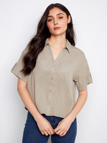 A stylish shirt with a classic collar, featuring short sleeves and button tabs for a versatile look. By Charlie B.