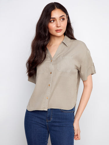 The shirt includes practical chest pockets, adding functionality to its fashionable style. By Charlie B.