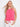Pink top with a stylish crew neckline, paired elegantly with white pants. Designed by Charlie B.