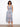 This dress features a flattering V-neck design that complements its elegant pattern. Perfect for any occasion. By Charlie B.