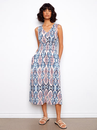 This dress features a flattering V-neck design that complements its elegant pattern. Perfect for any occasion. By Charlie B.