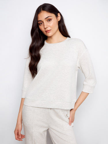 Subtle blanket stitch detailing elevates this piece with an understated charm that complements its cozy design by Charlie B.